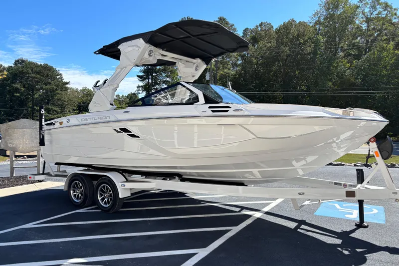 Slide: The Image of 2026 Centurion Ri230 boat with sleek design, parked outdoors on a sunny day. - 4