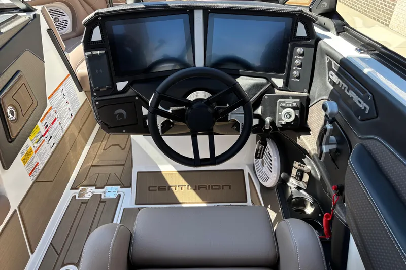 Slide: The Image of 2026 Centurion Ri230 boat interior with luxurious brown leather seating and built-in speakers. - 9