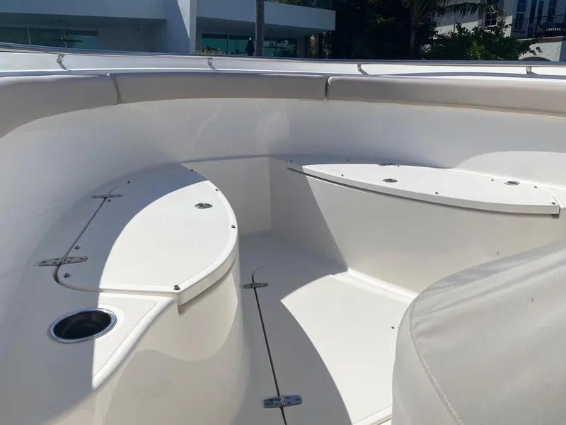 Slide: The Image of 2015 Pursuit S 280 Sport boat interior with white seating and storage compartments. - 14