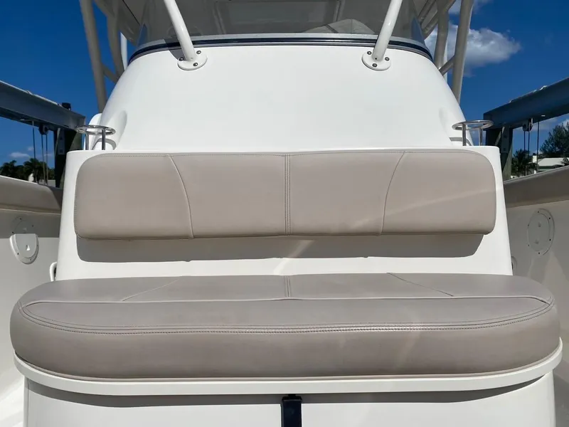 Slide: The Image of 2015 Pursuit S 280 Sport boat seat with beige cushions and sleek design. - 16