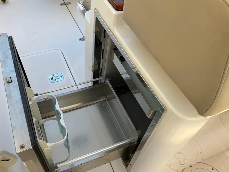 Slide: The Image of 2015 Pursuit S 280 Sport boat interior with open storage compartment. - 17