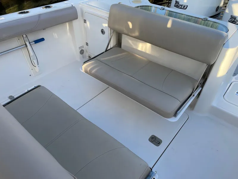Slide: The Image of 2015 Pursuit S 280 Sport boat interior with beige seating and clean deck. - 19