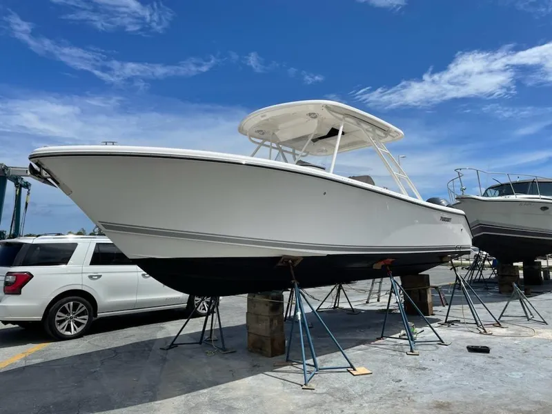 Slide: The Image of 2015 Pursuit S 280 Sport boat on stands, clear sky background. - 25
