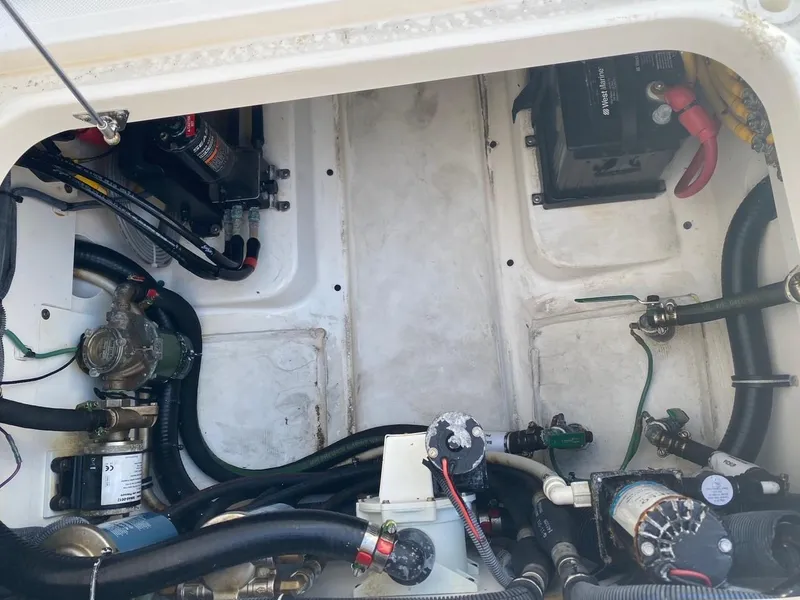 Slide: The Image of Engine compartment of a 2015 Pursuit S 280 Sport boat, showing various mechanical components. - 28