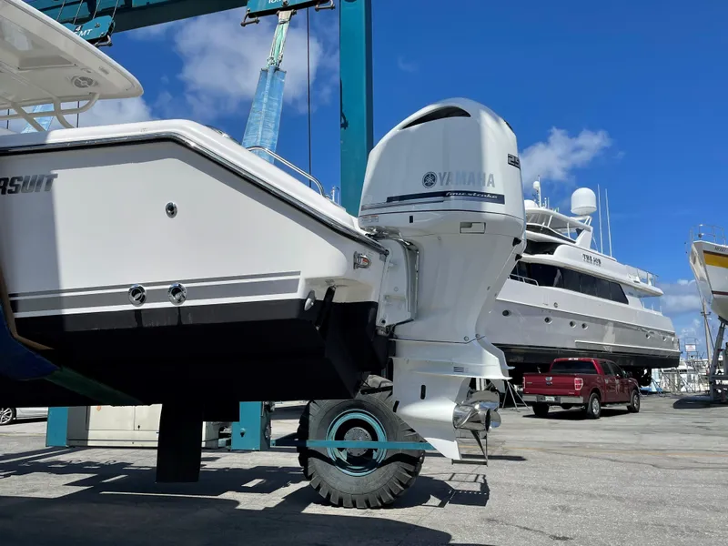 Slide: The Image of 2015 Pursuit S 280 Sport boat with Yamaha outboard motor in a marina setting. - 3