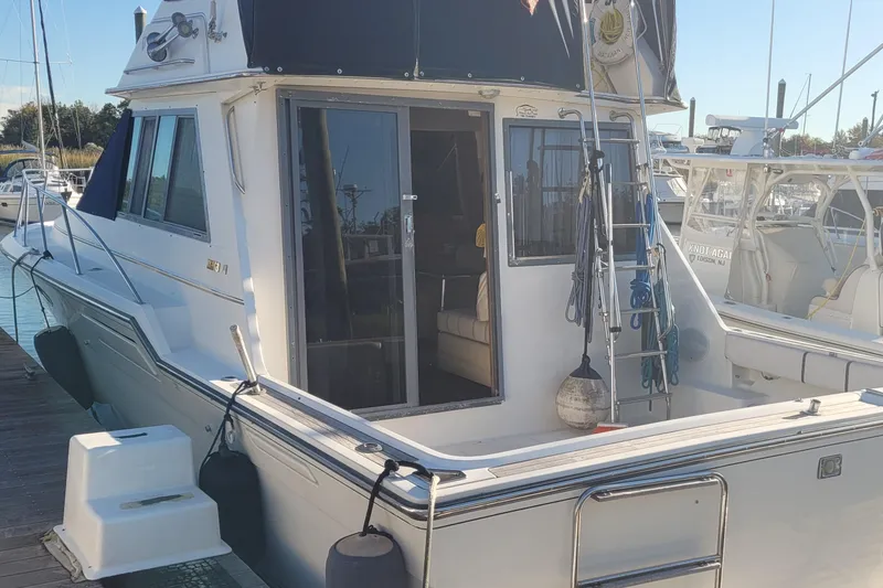 The Image of 1988 Tiara Yachts 3600 Convertible docked, showcasing rear deck and cabin entrance. - 0