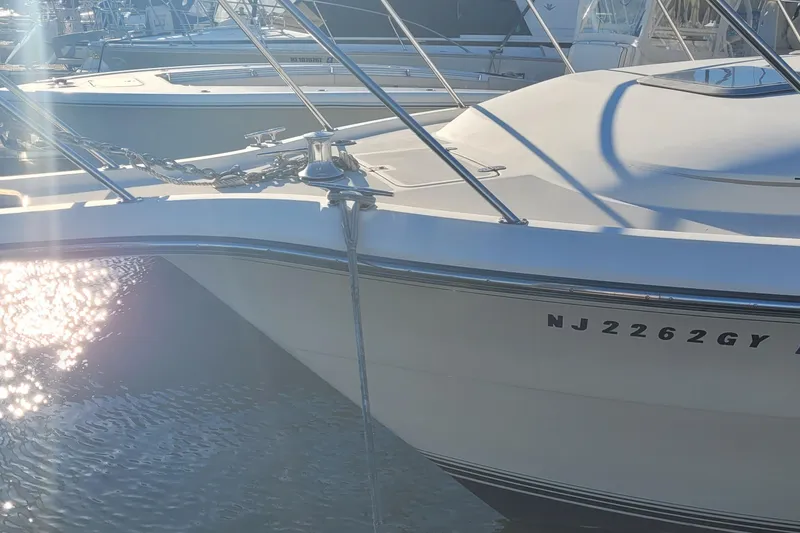 Slide: The Image of 1988 Tiara Yachts 3600 Convertible docked, reflecting sunlight on water. - 10