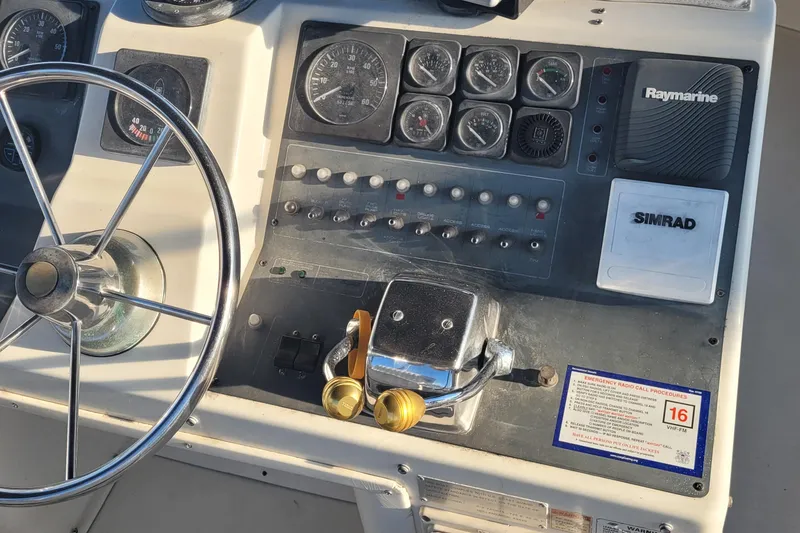 Slide: The Image of Control panel of a 1988 Tiara Yachts 3600 Convertible with steering wheel and navigation instruments. - 24