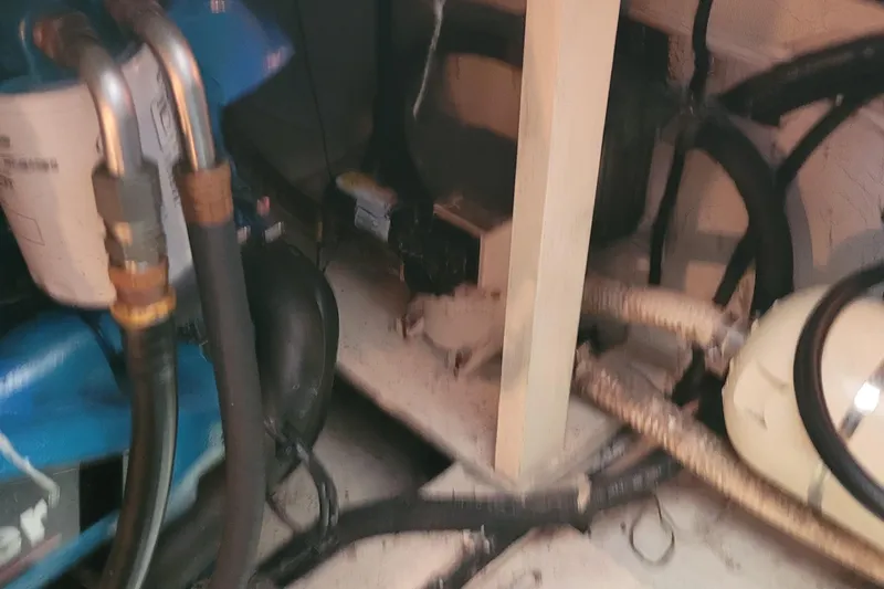 Slide: The Image of Engine room of 1988 Tiara Yachts 3600 Convertible with visible pipes and machinery. - 39