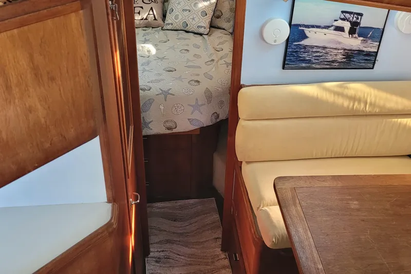 Slide: The Image of Interior of 1988 Tiara Yachts 3600 Convertible with cozy seating and nautical decor. - 44