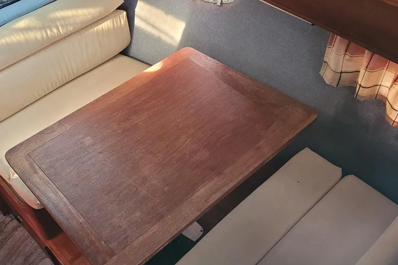 Slide: The Image of Interior of 1988 Tiara Yachts 3600 Convertible with wooden table and cushioned seating. - 45