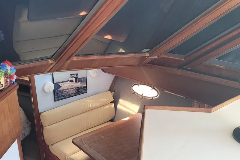 Slide: The Image of Interior of 1988 Tiara Yachts 3600 Convertible with cozy seating and nautical decor. - 46