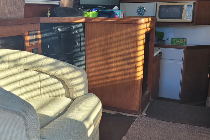 Slide: The Image of Interior of 1988 Tiara Yachts 3600 Convertible with cozy seating and kitchenette. - 48