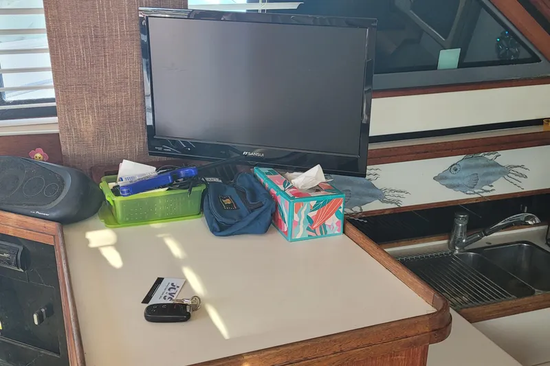 Slide: The Image of Interior of 1988 Tiara Yachts 3600 Convertible with TV, decor, and sink. - 50