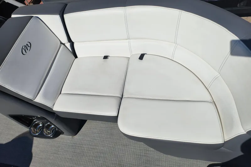 Slide: The Image of 2022 Manitou Aurora VP 23 boat interior with white cushioned seating. - 10