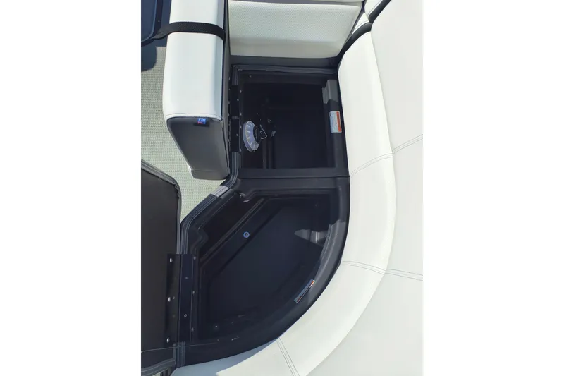 Slide: The Image of 2022 Manitou Aurora VP 23 boat interior storage compartment with cushioned seating. - 11