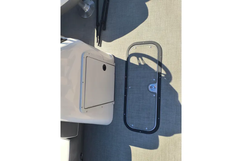 Slide: The Image of 2022 Manitou Aurora VP 23 boat interior with storage compartment and floor detail. - 14