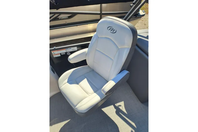 Slide: The Image of 2022 Manitou Aurora VP 23 boat seat with logo, featuring gray upholstery and armrests. - 17