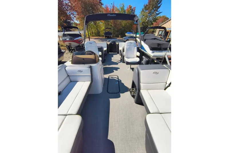 Slide: The Image of 2022 Manitou Aurora VP 23 pontoon boat with spacious seating and canopy, docked outdoors. - 18