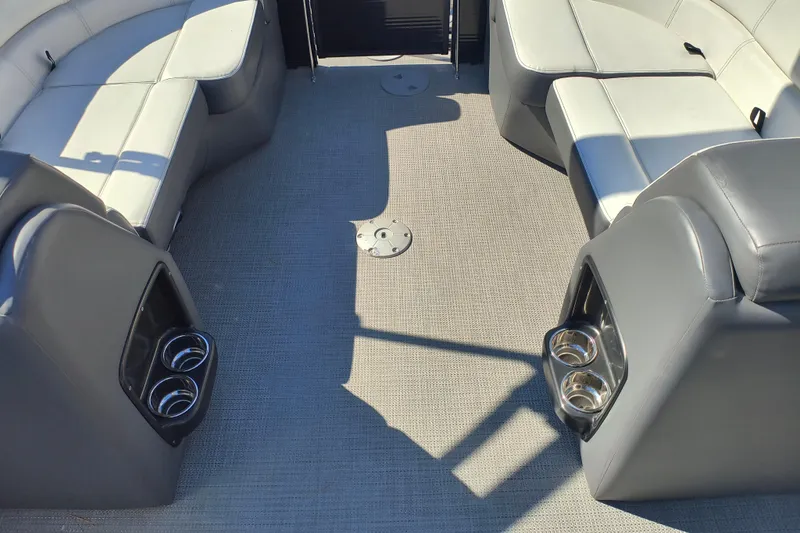 Slide: The Image of Interior of 2022 Manitou Aurora VP 23 pontoon boat with seating and cup holders. - 19