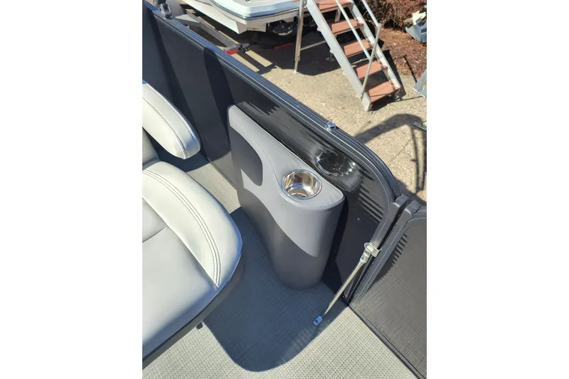 Slide: The Image of 2022 Manitou Aurora VP 23 boat interior with cup holder and seating. - 3