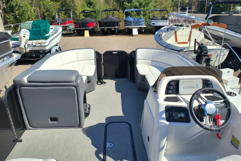 Slide: The Image of 2022 Manitou Aurora VP 23 pontoon boat interior with Garmin navigation system. - 5