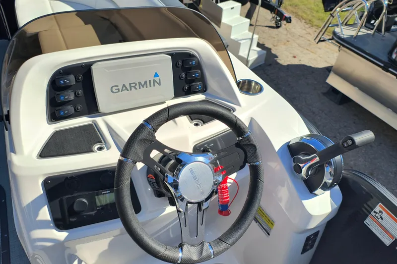 Slide: The Image of 2022 Manitou Aurora VP 23 boat dashboard with Garmin navigation system and steering wheel. - 6