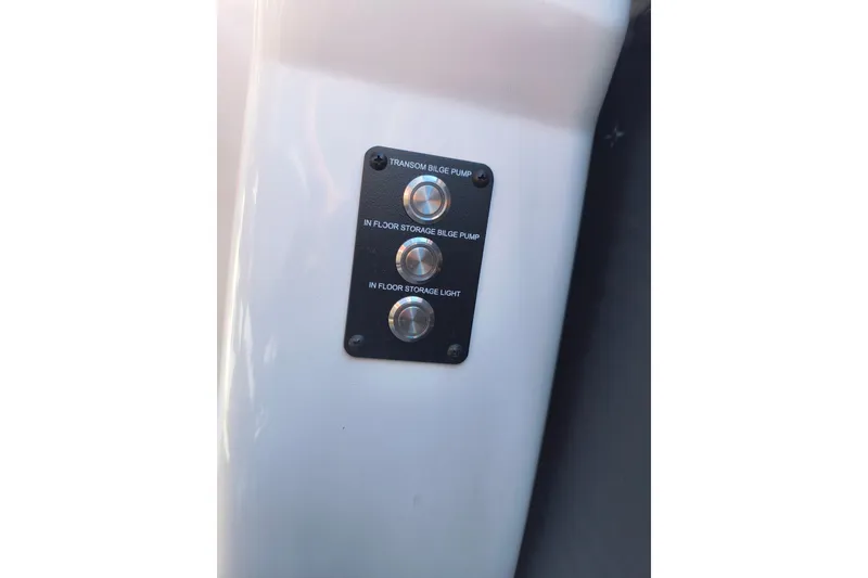 Slide: The Image of Control panel on 2022 Manitou Aurora VP 23 boat with bilge pump switches. - 8