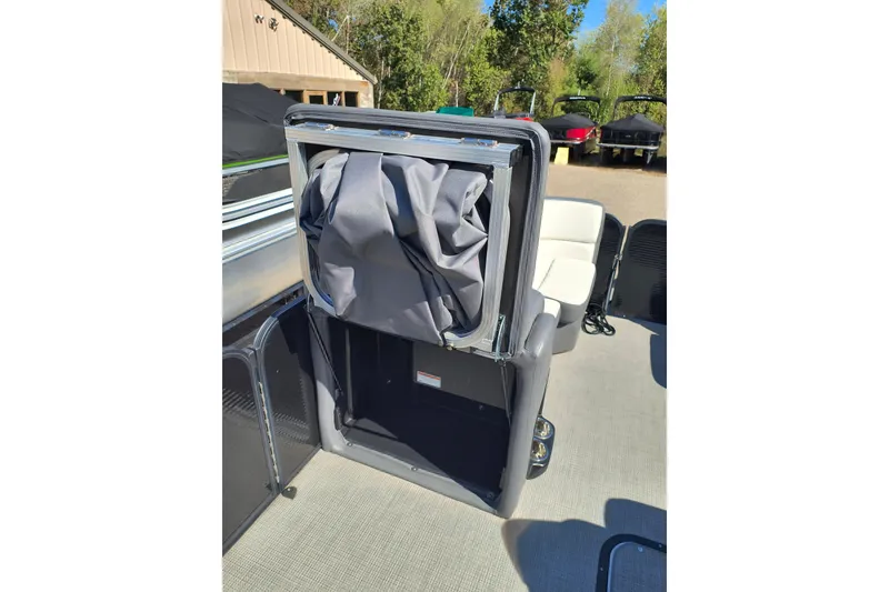 Slide: The Image of 2022 Manitou Aurora VP 23 boat interior with storage compartment open. - 9