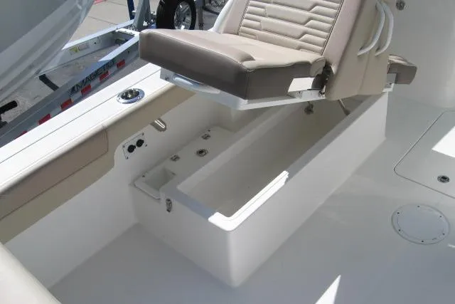 Slide: The Image of 2024 Edgewater 248CX Crossover boat interior with seating and storage compartment. - 11