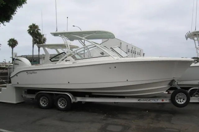 The Image of 2024 Edgewater 248CX Crossover boat on trailer, parked outdoors. - 3