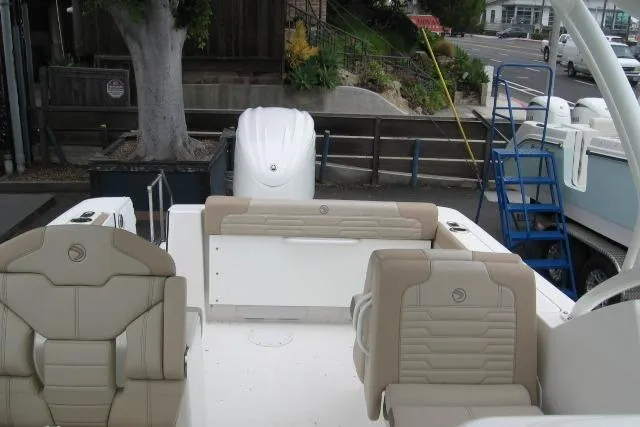 Slide: The Image of 2024 Edgewater 248CX Crossover boat interior with beige seating and modern design. - 4