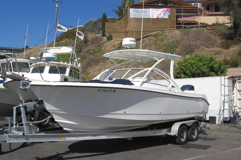 Slide: The Image of 2024 Edgewater 248CX Crossover boat on trailer, parked outdoors. - 21