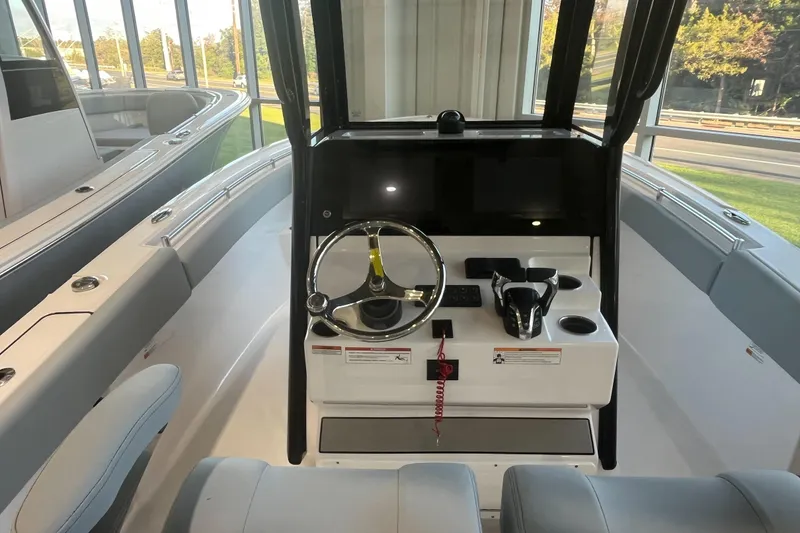 Slide: The Image of 2026 Sportsman Open 252 Center Console boat interior with steering wheel and controls. - 1