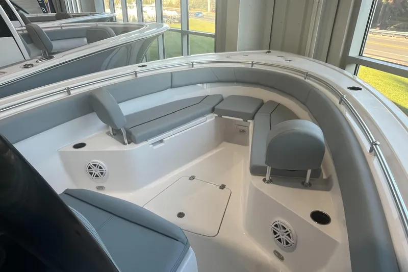 Slide: The Image of 2026 Sportsman Open 252 Center Console boat interior with cushioned seating and speakers. - 4