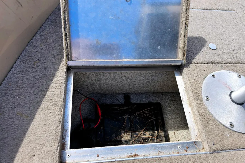 Slide: The Image of Open storage compartment in 2000 Alumacraft Navigator 165 CS boat, showing interior wiring. - 19