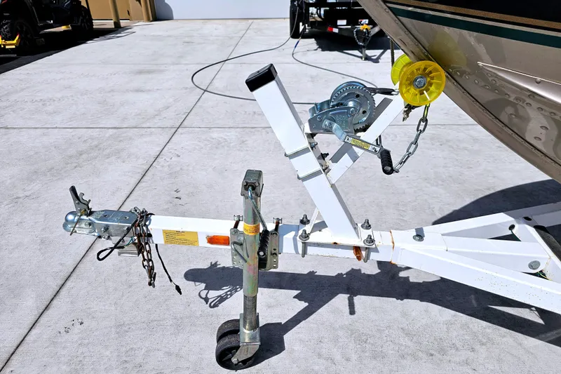 Slide: The Image of Trailer hitch and winch of 2000 Alumacraft Navigator 165 CS boat on concrete surface. - 27