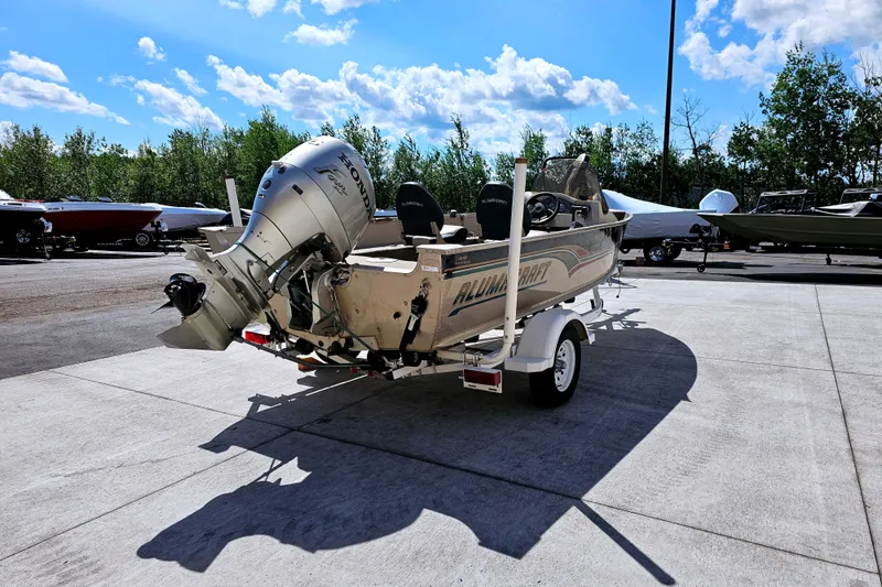 Slide: The Image of 2000 Alumacraft Navigator 165 CS boat on trailer with Honda outboard motor. - 4