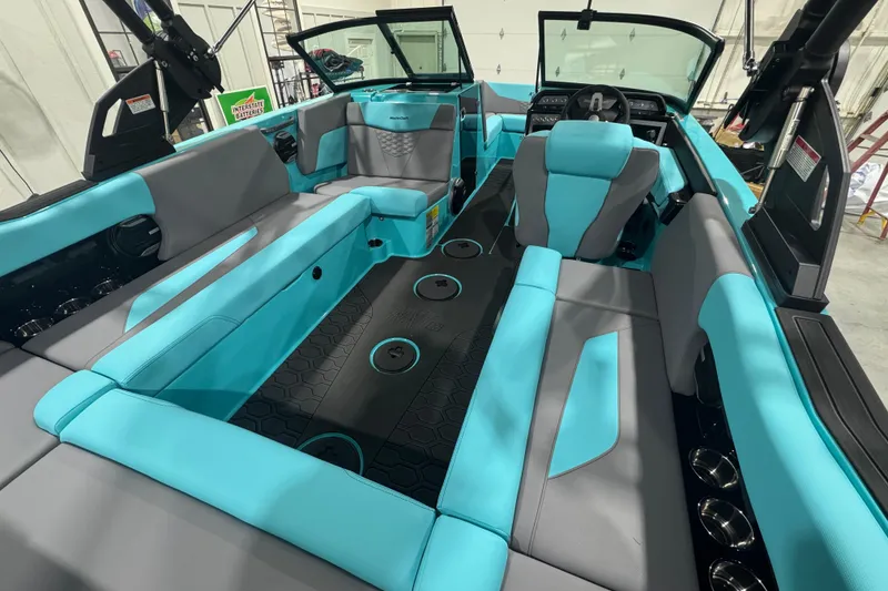 Slide: The Image of 2026 MasterCraft NXT22 boat interior with turquoise and gray seating, modern design. - 16