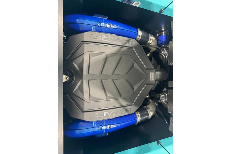 Slide: The Image of 2026 MasterCraft NXT22 engine with blue hoses and black cover. - 17