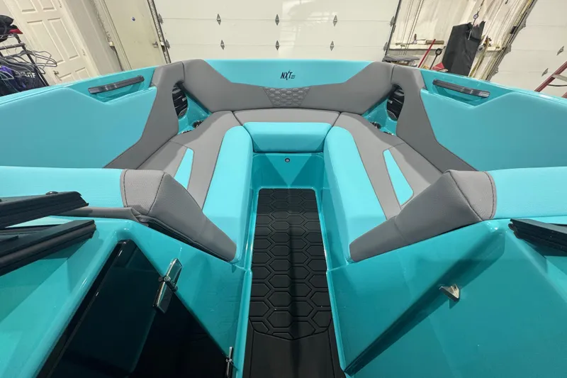 Slide: The Image of 2026 MasterCraft NXT22 boat interior with turquoise and gray seating. - 18
