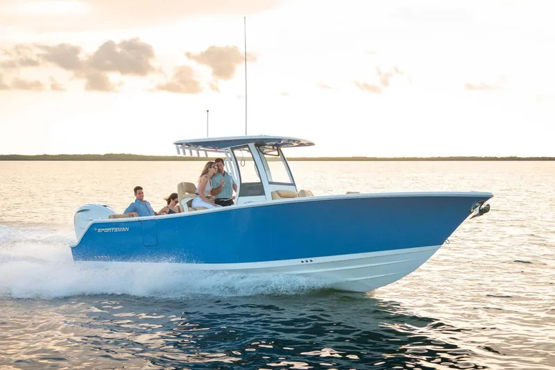 Slide: The Image of Manufacturer Provided Image: 2025 Sportsman Heritage 261 Center Console boat cruising on open water at sunset. - 0