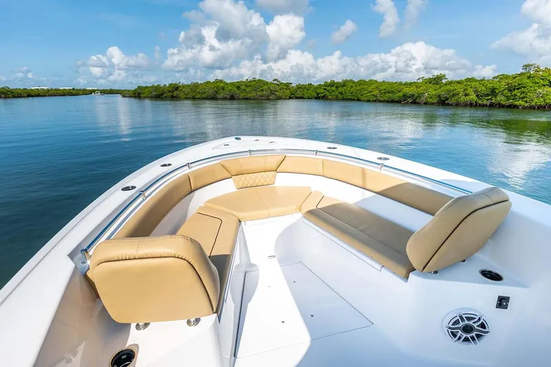 Slide: The Image of Manufacturer Provided Image: 2025 Sportsman Heritage 261 Center Console boat with tan seating on calm water. - 7