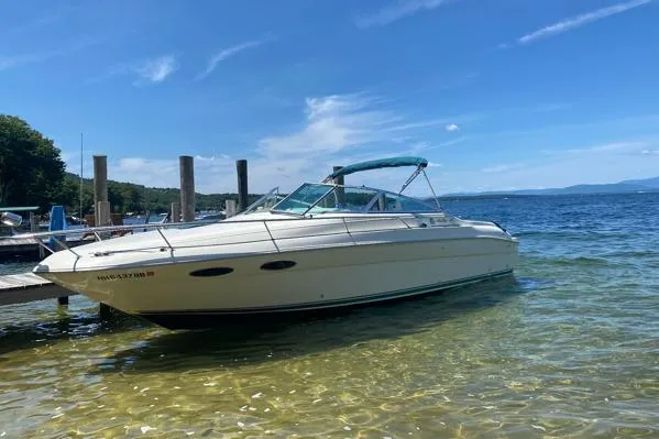 The Image of 1998 Sea Ray 280 Cuddy Cabin boat docked on clear, sunny lake. - 0