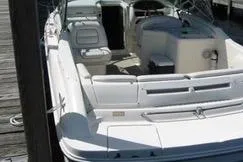 Slide: The Image of 1998 Sea Ray 280 Cuddy Cabin boat docked, featuring spacious seating and sleek design. - 1