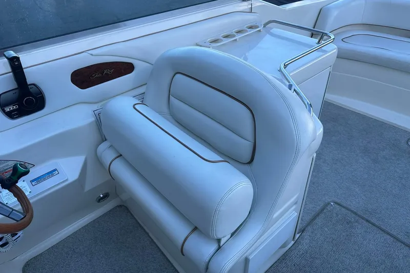 Slide: The Image of 1998 Sea Ray 280 Cuddy Cabin interior with white seating and control panel. - 11