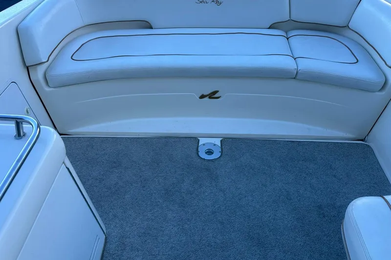 Slide: The Image of 1998 Sea Ray 280 Cuddy Cabin interior with cushioned seating and carpeted floor. - 13
