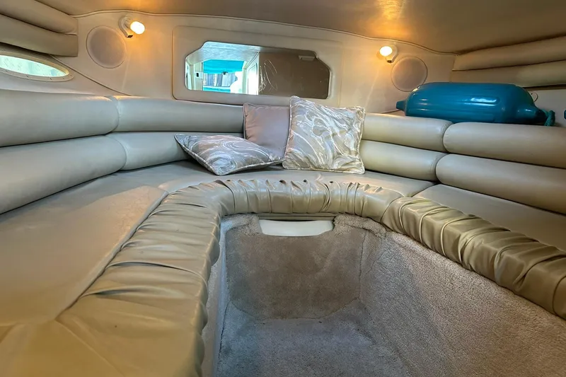 Slide: The Image of 1998 Sea Ray 280 Cuddy Cabin interior with plush seating and ambient lighting. - 14