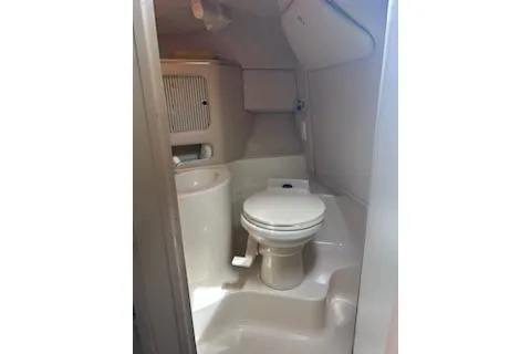 Slide: The Image of 1998 Sea Ray 280 Cuddy Cabin boat bathroom interior with toilet and sink. - 17