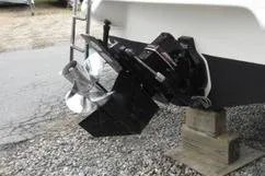 Slide: The Image of 1998 Sea Ray 280 Cuddy Cabin boat propeller and stern drive on gravel. - 19
